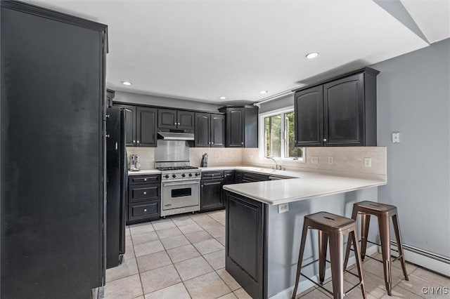 6924 Todd Way, Salina, NY 13088 - kitchen with stainless steel range, a peninsula, under cabinet range hood, decorative backsplash, and recessed lighting