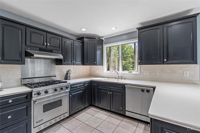 6924 Todd Way, Salina, NY 13088 - kitchen with appliances with stainless steel finishes, under cabinet range hood, light tile patterned flooring, light countertops, and tasteful backsplash