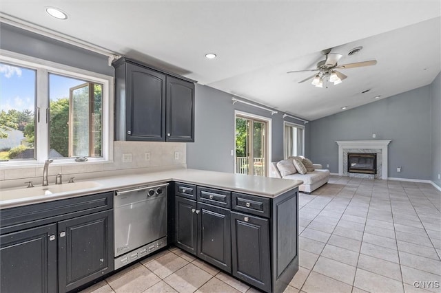 6924 Todd Way, Salina, NY 13088 - kitchen with dishwasher, vaulted ceiling, a peninsula, light tile patterned floors, and ceiling fan