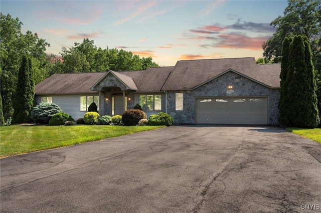 6924 Todd Way, Salina, NY 13088 - single story home with asphalt driveway, stone siding, a garage, and a front lawn