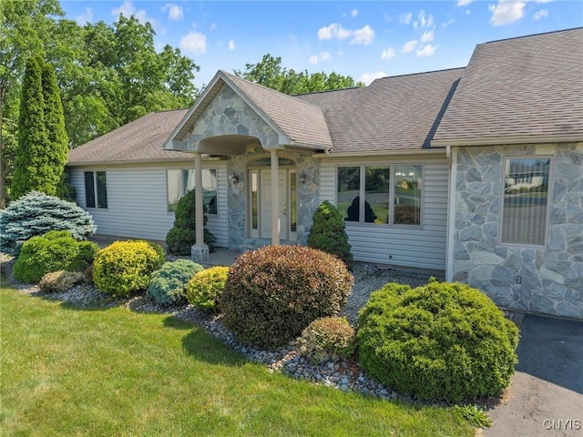 6924 Todd Way, Salina, NY 13088 - view of front of home with stone siding, a shingled roof, and a front yard