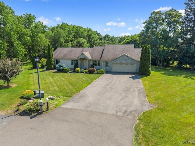 6924 Todd Way, Salina, NY 13088 - ranch-style house featuring stone siding, driveway, a garage, and a front yard