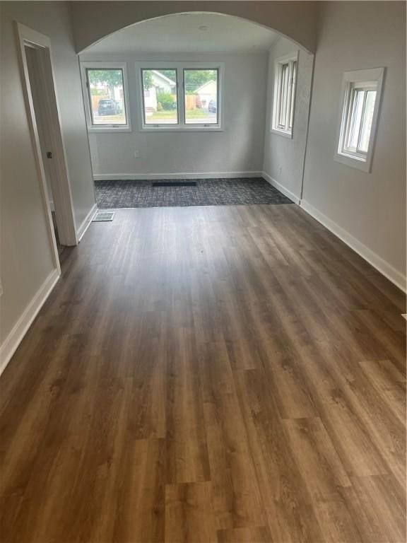 232 Almay Rd, Greece, NY 14616 - unfurnished room with arched walkways and dark wood finished floors