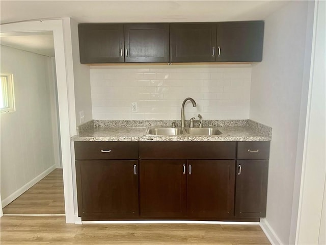 232 Almay Rd, Greece, NY 14616 - kitchen with light wood-style floors, dark brown cabinets, backsplash, and light countertops