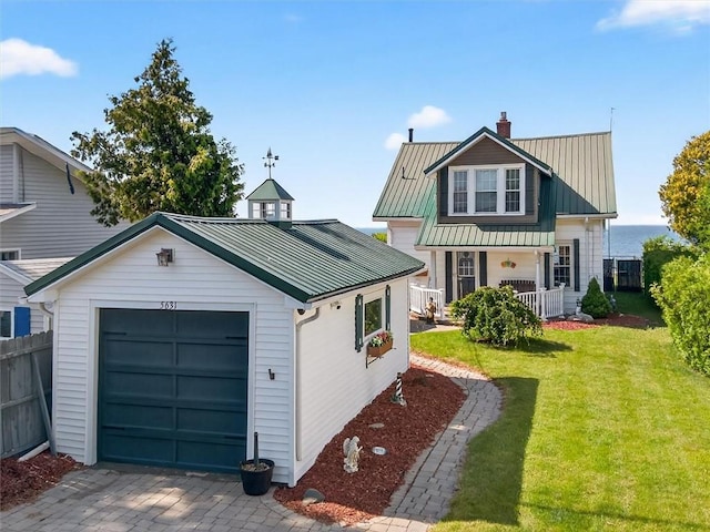 5631 W Blf, Newfane, NY 14126 - traditional-style home with a chimney, a metal roof, a garage, and a porch