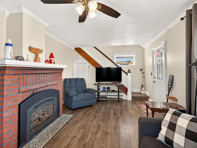 5631 W Blf, Newfane, NY 14126 - living area with wood finished floors, crown molding, a ceiling fan, stairs, and a brick fireplace