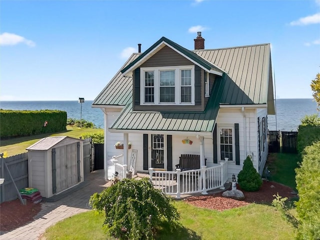 5631 W Blf, Newfane, NY 14126 - view of front of property with a porch, a water view, a storage shed, and a chimney