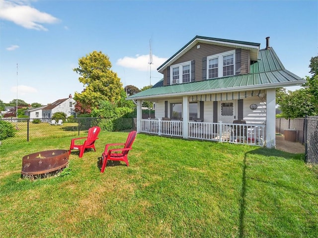 5631 W Blf, Newfane, NY 14126 - view of front of property featuring a fire pit, a fenced backyard, a metal roof, and a porch
