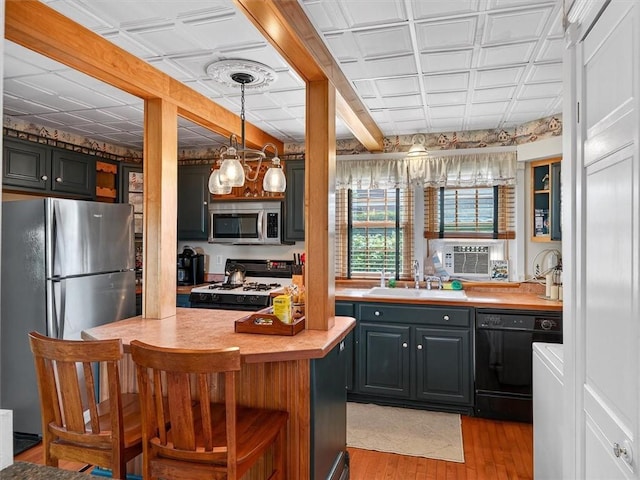5631 W Blf, Newfane, NY 14126 - kitchen featuring appliances with stainless steel finishes, light countertops, light wood-type flooring, an ornate ceiling, and a kitchen breakfast bar