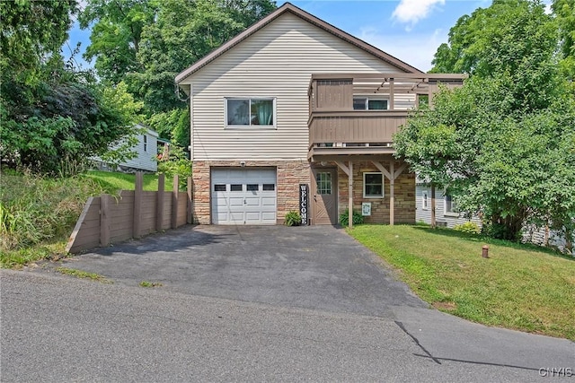 229 Gillespie Ave, Camillus, NY 13219 - view of front facade featuring stone siding, a garage, a front yard, and asphalt driveway