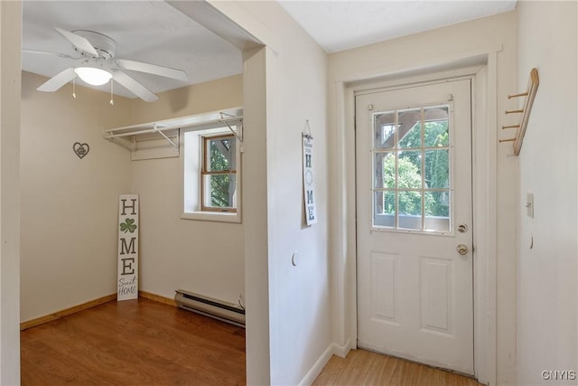 229 Gillespie Ave, Camillus, NY 13219 - entryway featuring a baseboard heating unit, healthy amount of natural light, light wood-type flooring, and a ceiling fan