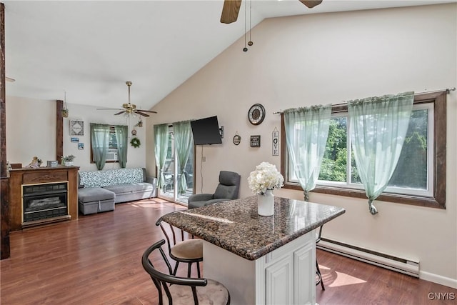 229 Gillespie Ave, Camillus, NY 13219 - kitchen with ceiling fan, a baseboard radiator, a breakfast bar, white cabinetry, and high vaulted ceiling
