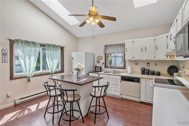 229 Gillespie Ave, Camillus, NY 13219 - kitchen featuring white appliances, baseboard heating, a skylight, a kitchen island, and dark wood-style flooring