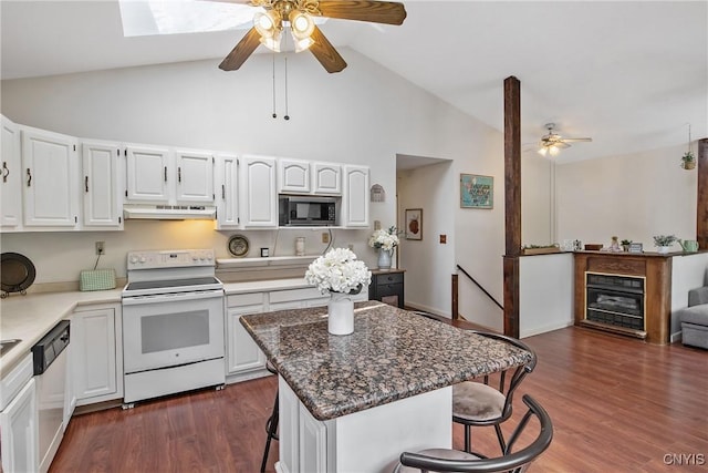 229 Gillespie Ave, Camillus, NY 13219 - kitchen featuring electric range, built in microwave, a ceiling fan, stainless steel dishwasher, and a kitchen bar