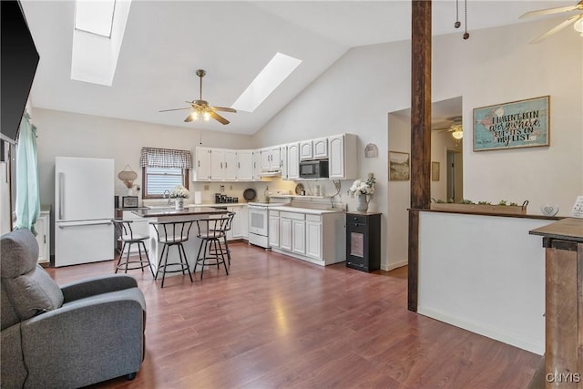 229 Gillespie Ave, Camillus, NY 13219 - kitchen featuring white appliances, a skylight, ceiling fan, and high vaulted ceiling
