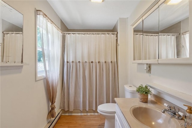 229 Gillespie Ave, Camillus, NY 13219 - bathroom featuring vanity, wood finished floors, a shower with shower curtain, and baseboard heating