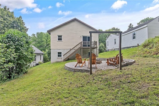 229 Gillespie Ave, Camillus, NY 13219 - rear view of property featuring a fire pit, stairway, a lawn, and a wooden deck