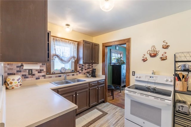 82 Barnard St, Greece, NY 14616 - kitchen with white electric stove, light countertops, light wood-style flooring, decorative backsplash, and healthy amount of natural light