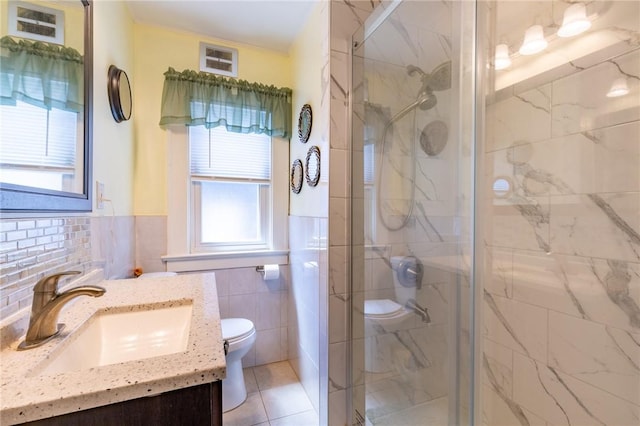 82 Barnard St, Greece, NY 14616 - full bathroom featuring vanity, tile walls, a shower stall, wainscoting, and tile patterned floors