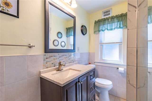 82 Barnard St, Greece, NY 14616 - bathroom with tile walls, vanity, tile patterned flooring, and wainscoting