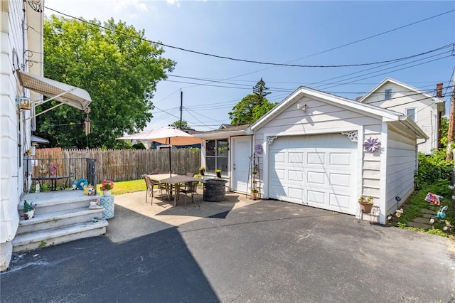 82 Barnard St, Greece, NY 14616 - view of front of property with an outdoor structure, a detached garage, and outdoor dining area