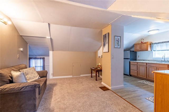 82 Barnard St, Greece, NY 14616 - living area featuring vaulted ceiling and light colored carpet