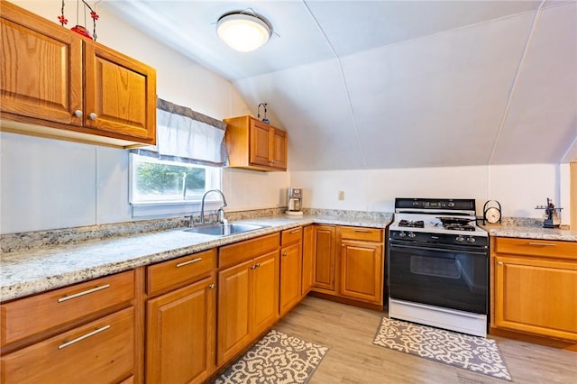 82 Barnard St, Greece, NY 14616 - kitchen featuring gas range gas stove, lofted ceiling, light wood-style flooring, brown cabinets, and light stone countertops
