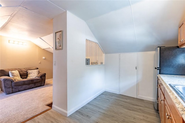 82 Barnard St, Greece, NY 14616 - kitchen with light wood-type flooring, lofted ceiling, and light countertops
