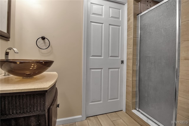1007 87th St, Niagara Falls, NY 14304 - bathroom with a stall shower, vanity, and wood finished floors