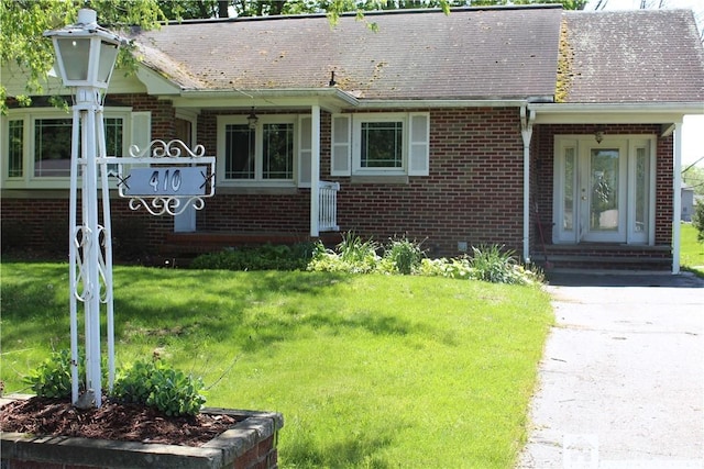 410 Chestnut St, Pomfret, NY 14063 - view of front of property with brick siding, a front yard, and a shingled roof