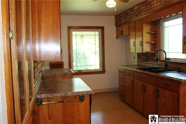 410 Chestnut St, Pomfret, NY 14063 - kitchen featuring plenty of natural light, brown cabinetry, and a ceiling fan