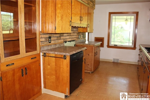 410 Chestnut St, Pomfret, NY 14063 - kitchen featuring brown cabinets, healthy amount of natural light, dishwasher, and tasteful backsplash