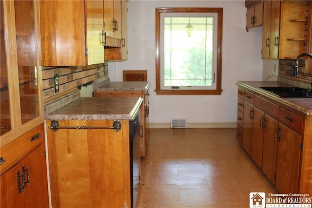 410 Chestnut St, Pomfret, NY 14063 - kitchen featuring tasteful backsplash and brown cabinetry