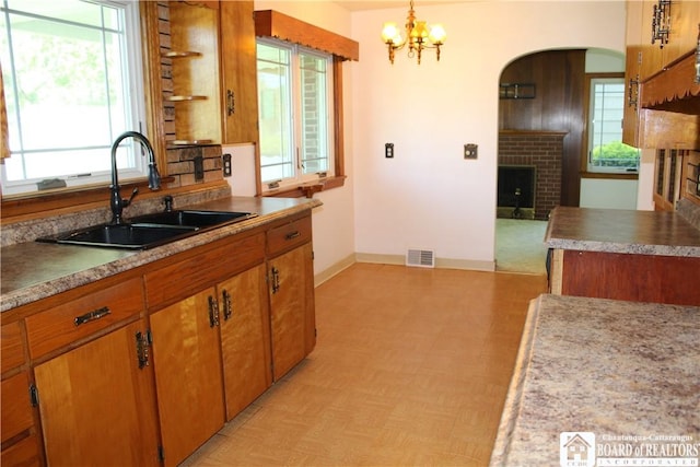 410 Chestnut St, Pomfret, NY 14063 - kitchen featuring a fireplace, light flooring, and plenty of natural light