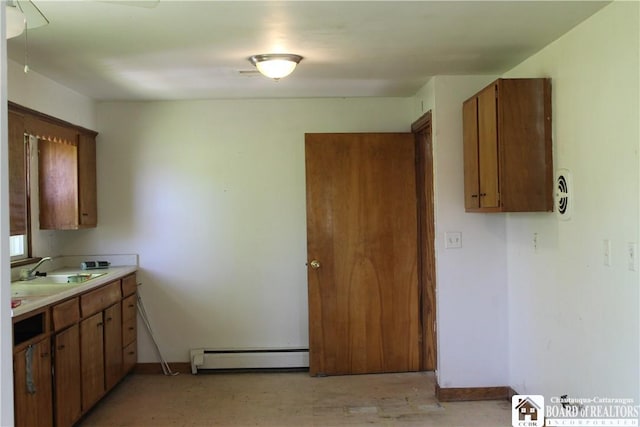410 Chestnut St, Pomfret, NY 14063 - kitchen with a baseboard heating unit, light countertops, and brown cabinetry