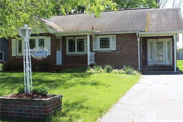 410 Chestnut St, Pomfret, NY 14063 - view of front of house with brick siding, a front lawn, and roof with shingles