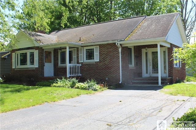 410 Chestnut St, Pomfret, NY 14063 - ranch-style home with brick siding, a front lawn, a porch, and a shingled roof