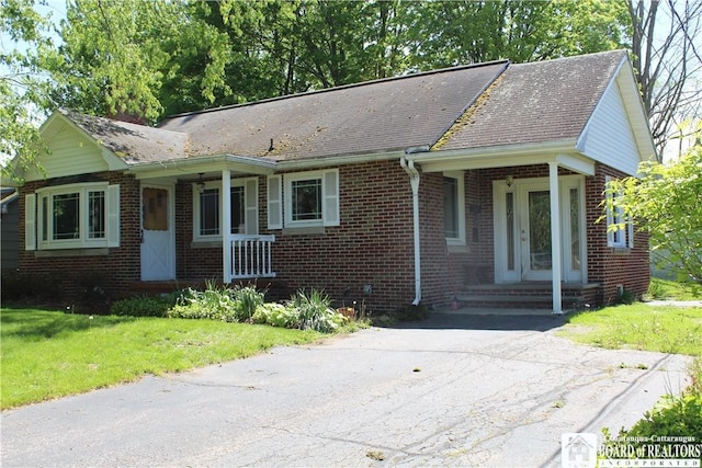 410 Chestnut St, Pomfret, NY 14063 - ranch-style home featuring brick siding, a front lawn, and a shingled roof