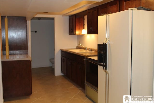 410 Chestnut St, Pomfret, NY 14063 - kitchen featuring white fridge with ice dispenser, light countertops, light tile patterned flooring, range, and dark brown cabinets