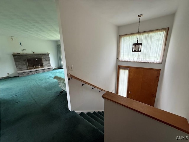 2359 Sands Rd, Camillus, NY 13031 - entrance foyer with carpet flooring, a stone fireplace, and stairway