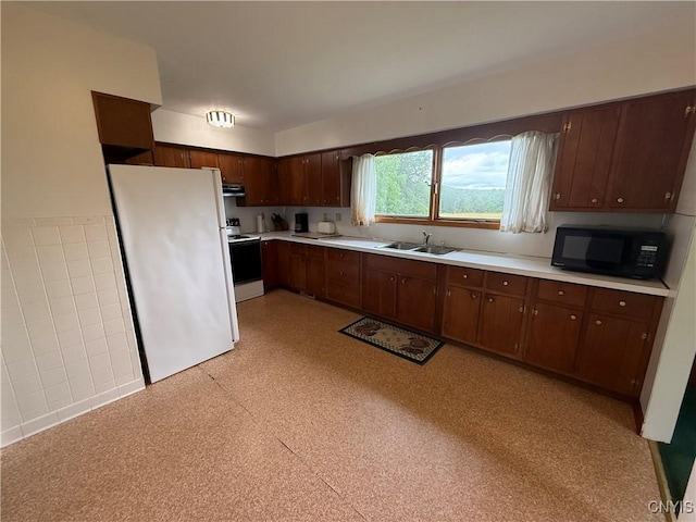 2359 Sands Rd, Camillus, NY 13031 - kitchen with white appliances, light countertops, under cabinet range hood, and dark brown cabinets