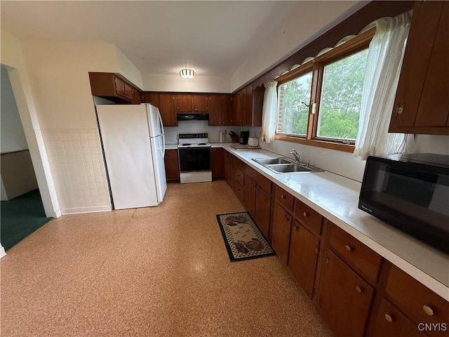 2359 Sands Rd, Camillus, NY 13031 - kitchen featuring white appliances, under cabinet range hood, light countertops, light flooring, and wainscoting