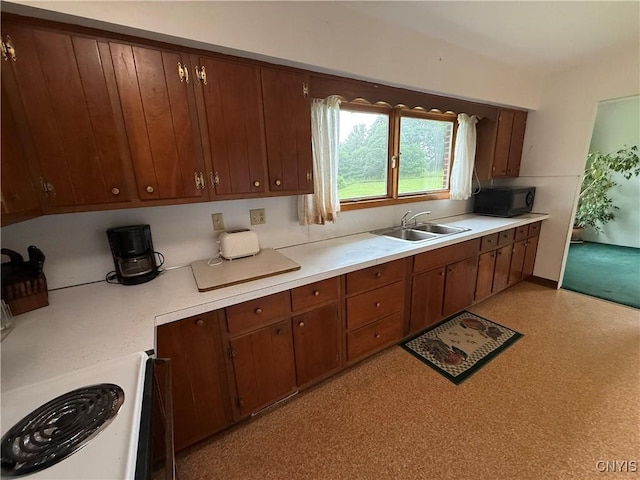 2359 Sands Rd, Camillus, NY 13031 - kitchen featuring stove, black microwave, light countertops, and brown cabinets