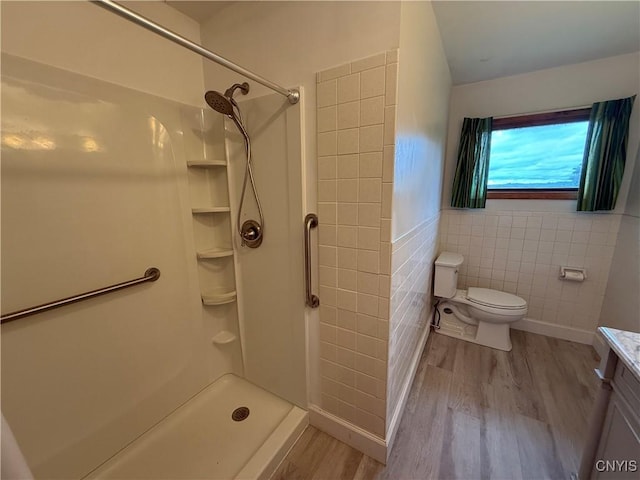 2359 Sands Rd, Camillus, NY 13031 - bathroom with wood finished floors, tile walls, a shower, and vanity