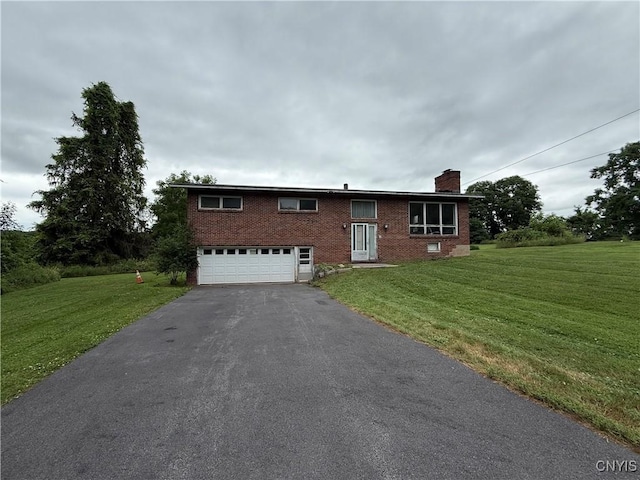 2359 Sands Rd, Camillus, NY 13031 - ranch-style house with a chimney, brick siding, an attached garage, asphalt driveway, and a front lawn