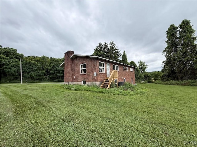 2359 Sands Rd, Camillus, NY 13031 - rear view of property with a chimney, brick siding, and a yard