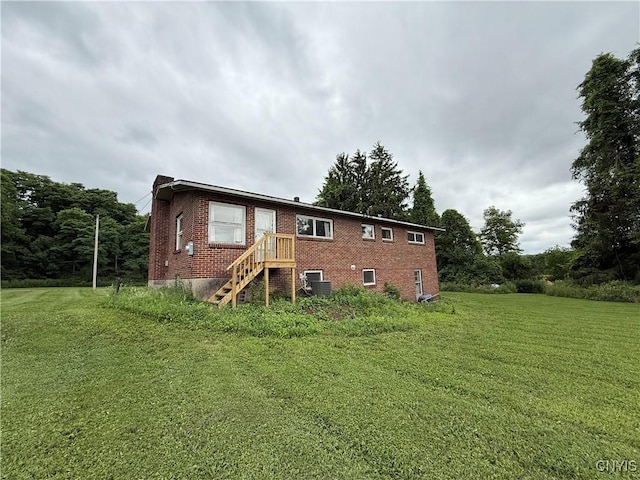 2359 Sands Rd, Camillus, NY 13031 - rear view of property featuring brick siding and a lawn
