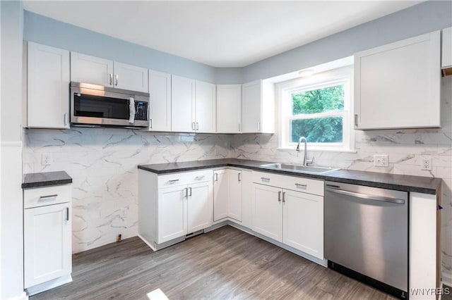 539 Windermere Blvd, Amherst, NY 14226 - kitchen with appliances with stainless steel finishes, dark countertops, wood finished floors, and white cabinets
