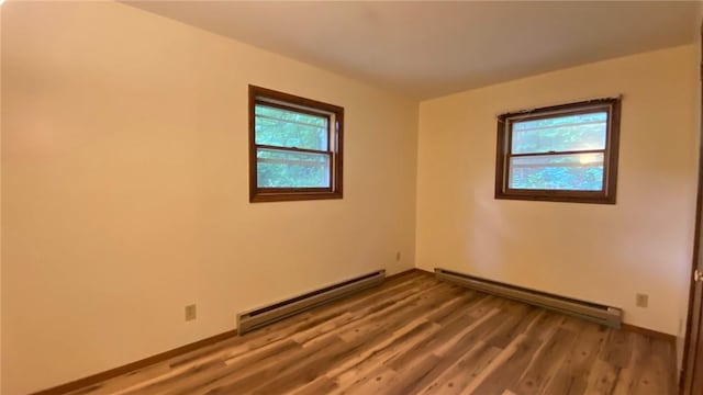 1221 Garden Ln, Middlesex, NY 14507 - unfurnished room with baseboard heating, plenty of natural light, and wood finished floors