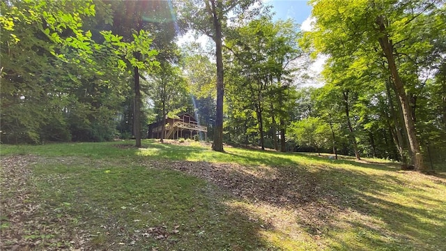 1221 Garden Ln, Middlesex, NY 14507 - view of grassy yard featuring a wooded view and a deck